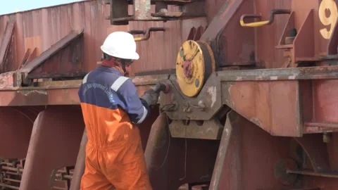 Crew member preparing hatch coaming surface area for painting Video stock 290016735