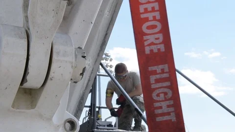 Crew members perform maintenance work on B-1 aircraft at Air Force base - 2017 Stock Footage 92312316