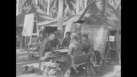 Crew members play card and operation board with all records of operation - 1944 Stock Footage 99786373