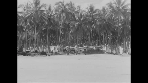 Crew members remove the camera from aircraft as it lands - 1944 Stock Footage 99786429