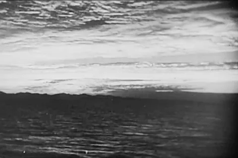 Crew men load shells in the gun for firing from battleship - 1950 Stock Footage 103590429