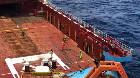 Crew of an offshore support vessel engaged in a towing equipment preparation Stock-Footage 98494122