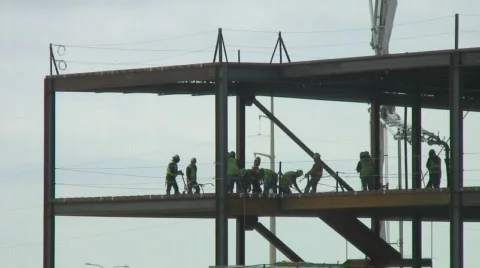 Crew pours concrete on upper floor of building Stock Footage 110111