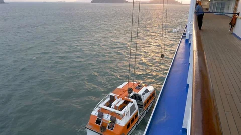 Crew prepares to attach hoisting tackle to tender boat Stock Footage 108199163