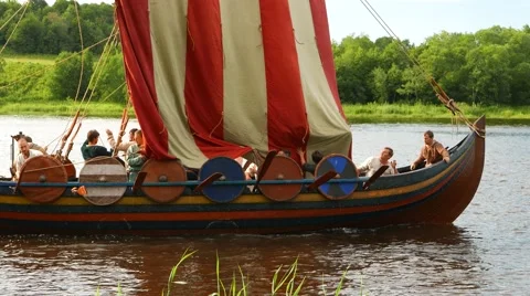Crew strike down striped sail at traditional viking longship boat, small vessel 스톡 동영상 61719149