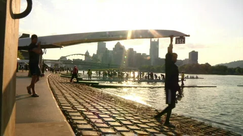 Crew Team Carries Boat Above Heads to the Water in Unison Stock Footage