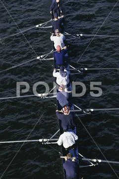 Crew team rowing on water Stock Photos
