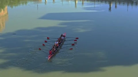 A crew team rows near a bridge on the Tiber River in Rome, Italy. Stock Footage 143079519