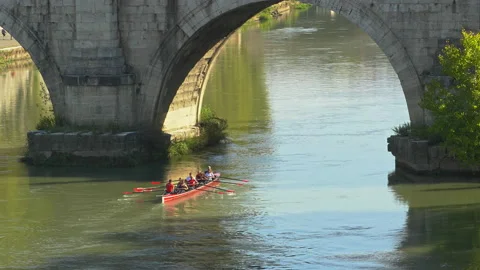 A crew team rows near a bridge on the Tiber River in Rome, Italy. Stock-Footage 143161457