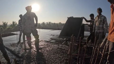 Crew Using Concrete Mixer Machine for Foundation Work at Rural Building Site Stock Footage 337790024