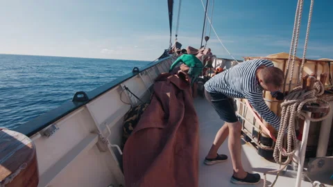 Crew work on the big sailing boat moving in the Atlantic Ocean under the sails Stock Footage 343630083