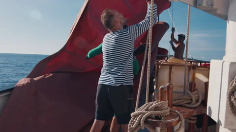 Crew work on the big sailing boat moving in the Atlantic Ocean under the sails Stock Footage 344957789