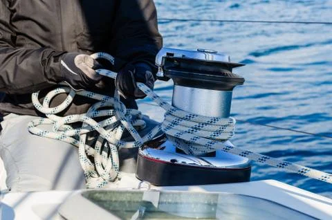 Crew work with genoa sheet rope and winch Fotos de archivo