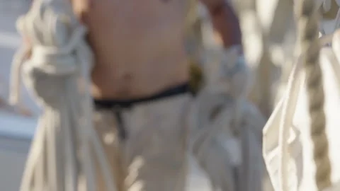 Crew work with the sails on the big expeditional sailing vessel moving in the Stock Footage 340985241