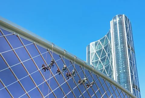 A crew of workers is cleaning the facade of a building Stock Photos
