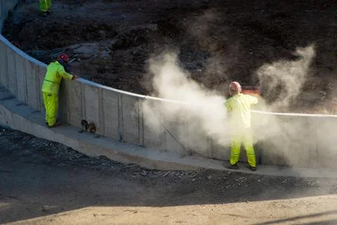 Crew of workers cutting and observing concrete Stock Photos
