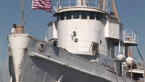 Crewman lowering flag on Tamaroa Tug in Baltimore, Maryland USA Stock Footage 105487556