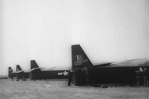 Crewmen work on Horsa glider and men paint U.S. insignia on gliders - 1940 Video stock 103712951