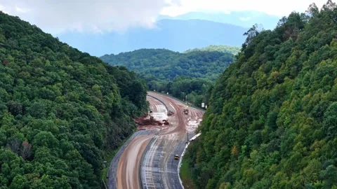 Crews work to clear Interstate 40 from Hurricane Helene mudslide Stock Footage 299827873