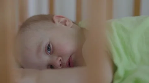 In crib child lying down face serene tranquility in close-up. Night unfolds Stock-Footage 290241367