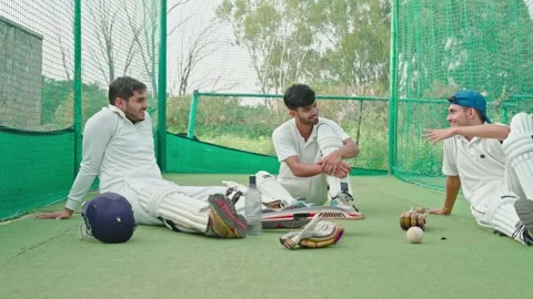 Cricket player having chit chat with their teammates after having net practice Stock Footage 251644971