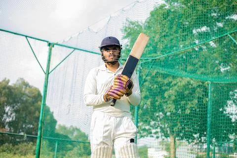 Cricket player is ready to practice batting in the nets during his practice time Stock Photos