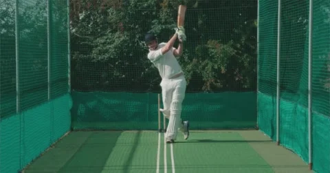 Cricketer hits ball hard in nets. Vídeo Stock 58840843
