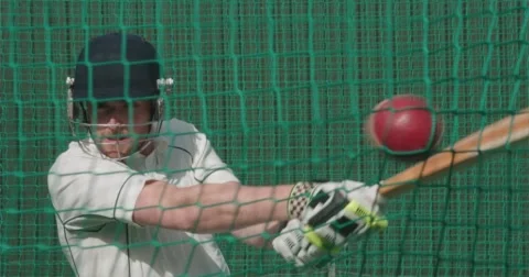 Cricketer plays shot towards camera in nets. Video stock 58836231