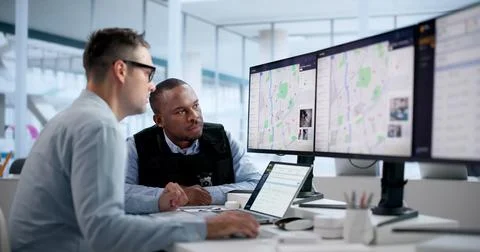 Crime Analyst Studies Crime Patterns On Laptop Using Geospatial Software Tool Stock Photos