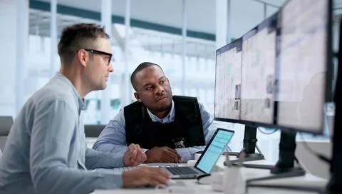 Crime Analyst Studies Geospatial Data On Laptop To Map Crime Patterns. Stock Photos