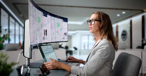 Crime Analyst Studies Geospatial Data On Computer For Policing Insights. Stock Photos