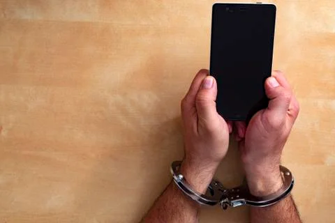 Crime concept in the network using a smartphone. Stock Photos
