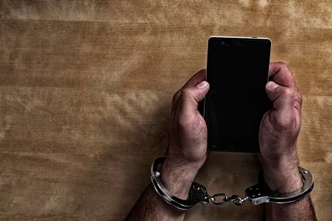 Crime concept in the network using a smartphone. Stock Photos