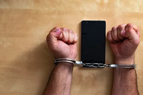 Crime concept in the network using a smartphone. Stock Photos
