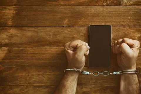 Crime concept in the network using a smartphone. Stock Photos