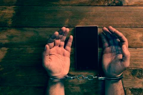 Crime concept in the network using a smartphone. Stock Photos