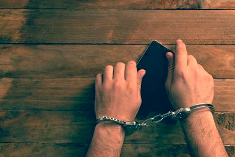 Crime concept in the network using a smartphone. Stock Photos