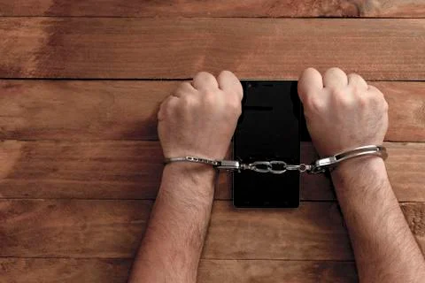 Crime concept in the network using a smartphone. Stock Photos