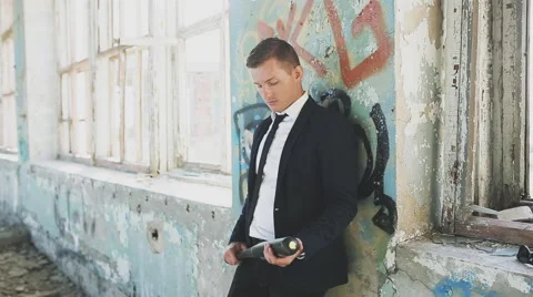 Crime man in a suit with bat in abandoned building Stock Footage 66876751