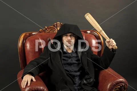 Crime or aggression and violence concept. Bearded man with baseball bat sit in Stock Photos