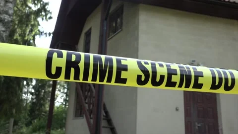 Crime Scene and Do Not Cross sign in front of a house Stock Footage 239594186