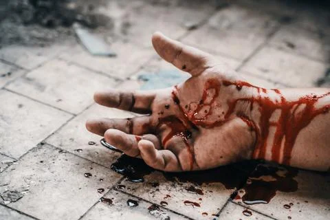Crime scene with human hand in blood on floor of killed man by murder, dead body Stock Photos
