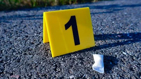 Crime scene marker identifying discarded nicotine pouch Stock Photos