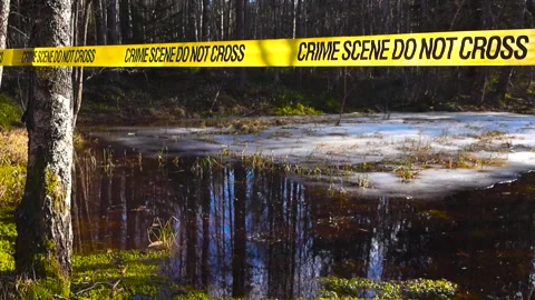 Crime scene tape blocking access to a frozen lake Stock Footage 331438934