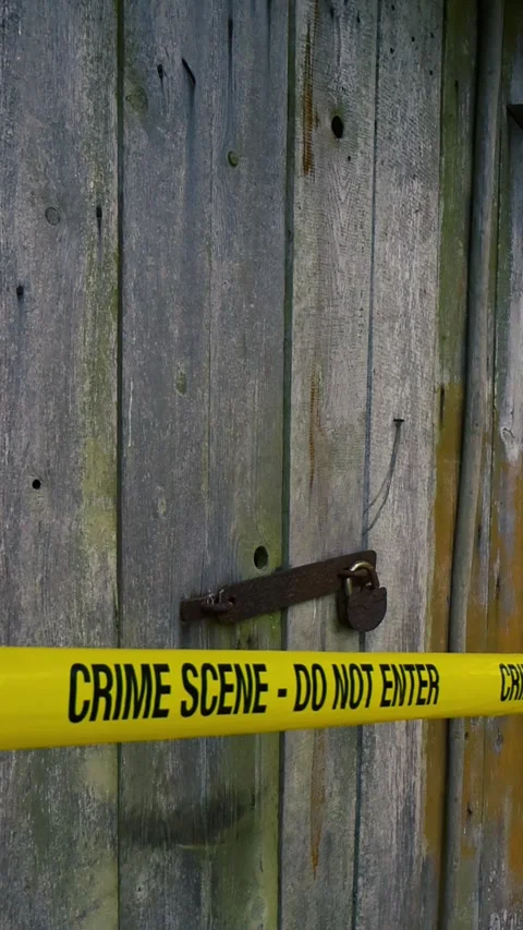 Crime scene tape blocking entry to old barn Stock Footage 341324457