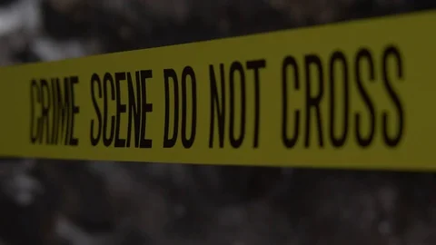 CRIME SCENE TAPE UNROLLED.  ND BACKGROUND. Stock Footage