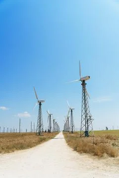 Crimea, August 15, 2022: Windmill farm, wind generators on a beautiful bright Stock Photos