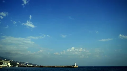 Crimea, Yalta. Lighthouse clouds in the sky and sailing ships. 4k Stock Footage 142014885