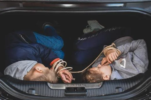 Crimes with children. Victims of children in trunk of car. Illegal Imprisonment Stock Photos