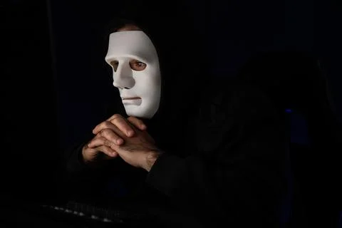 Criminal anonymous mask's hack programmer trying to approach main data. Surmise. Stock Photos